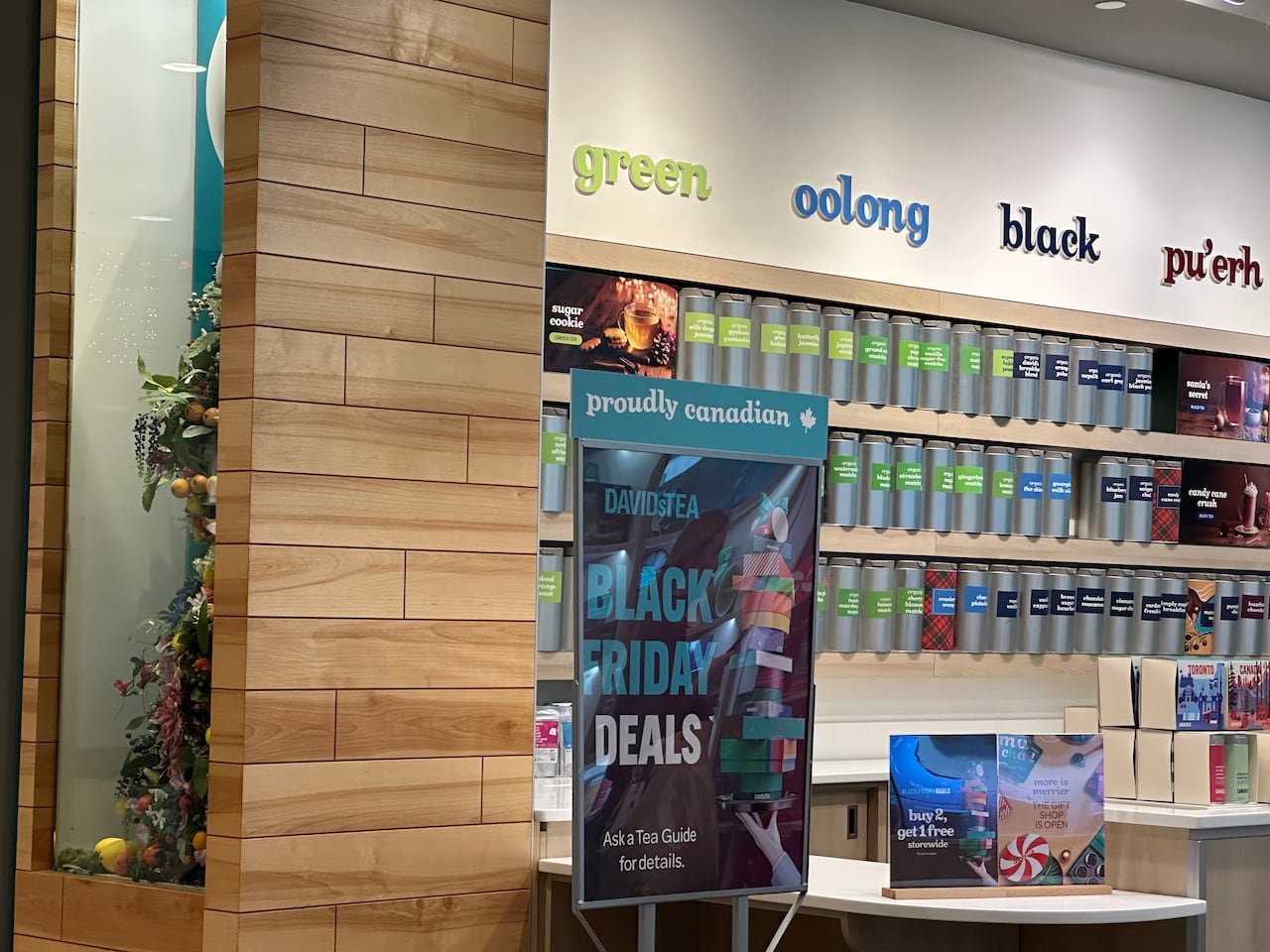 A sign reads 'proudly Canadian' outside of a David's Tea store.