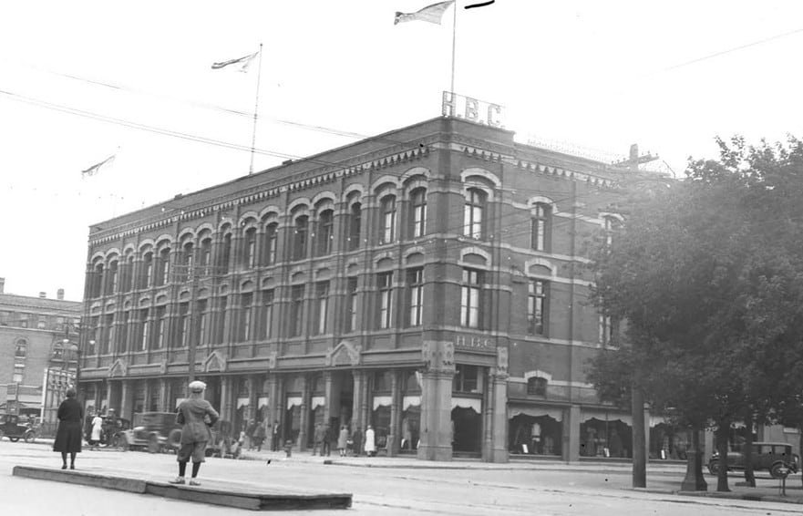 Black and white photo of a three-storey brick building