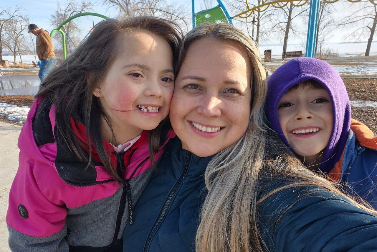 default-307 A mother with two kids takes a selfie in a Calgary park.